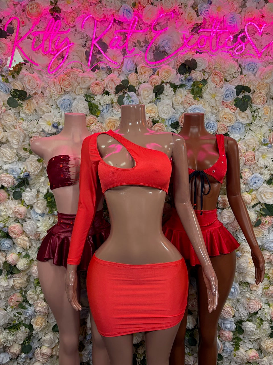 Mannequins wearing red tie-front crop tops and mini skirts