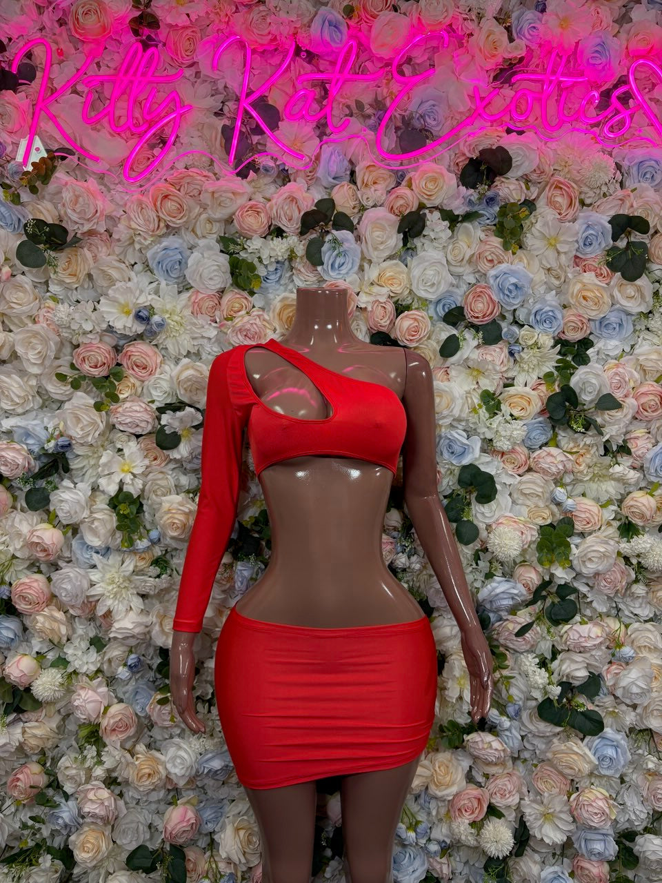 Red one-shoulder cutout crop top and mini skirt set on mannequin