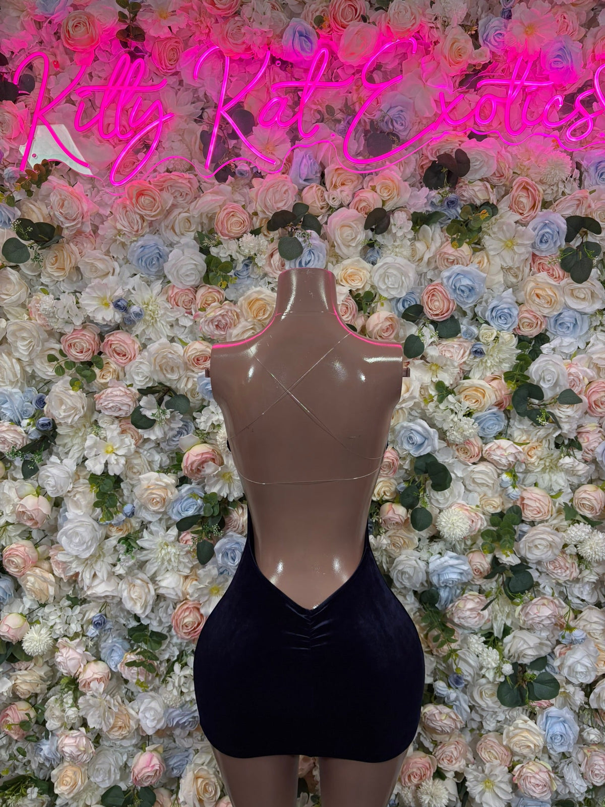 Black sleeveless bodycon mini dress with open back cutout, mannequin view