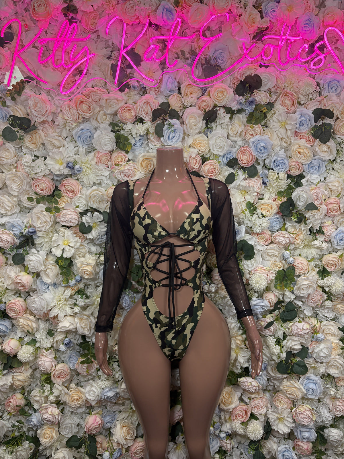 Sheer black bodysuit with olive snakeskin print, crisscross lace-up front, long sleeves