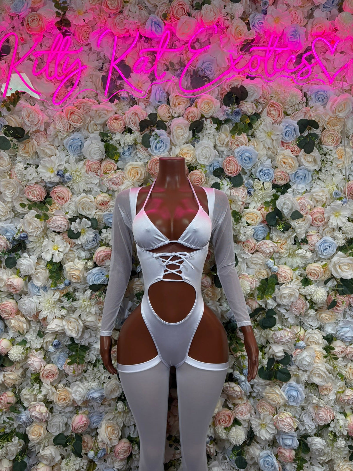 White long-sleeve cutout one-piece bodysuit with triangle chest cutout, strappy waist detail, high legs