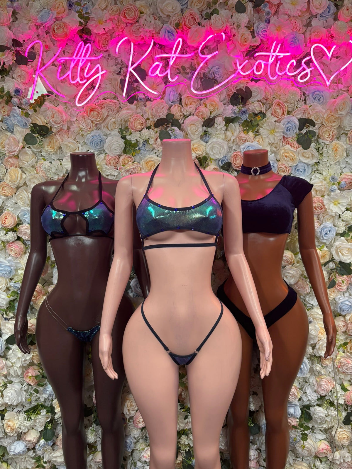 Iridescent metallic micro bikini set on mannequins, triangle tops and thong-like bottoms