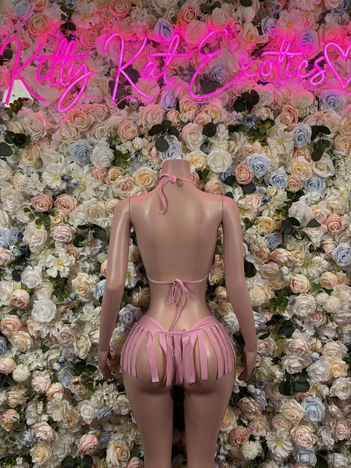 Blush pink halter bikini set back view with fringe tassels and skirted bottoms
