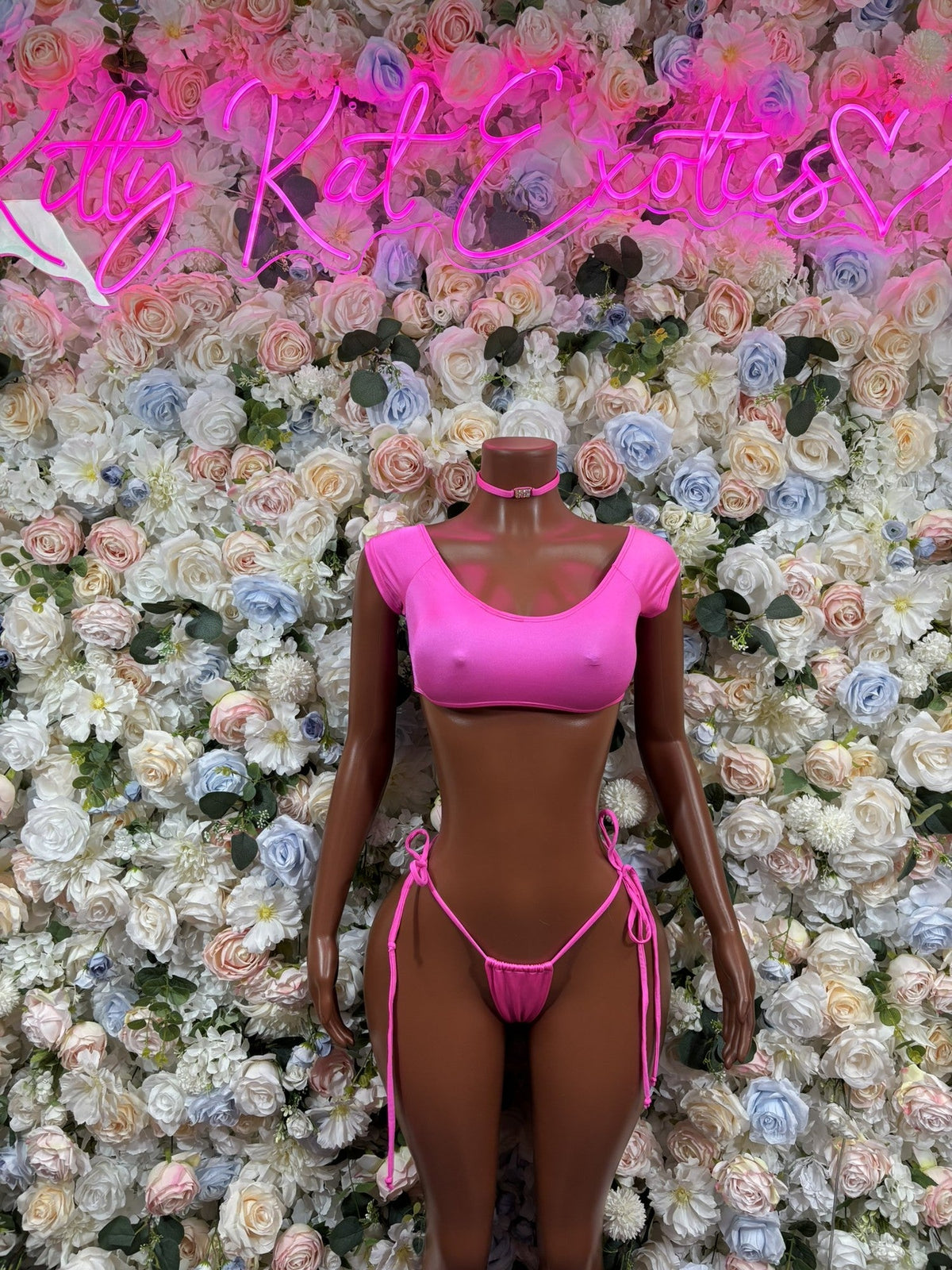 Neon pink halter bikini set with tie-side bottoms and matching side ties