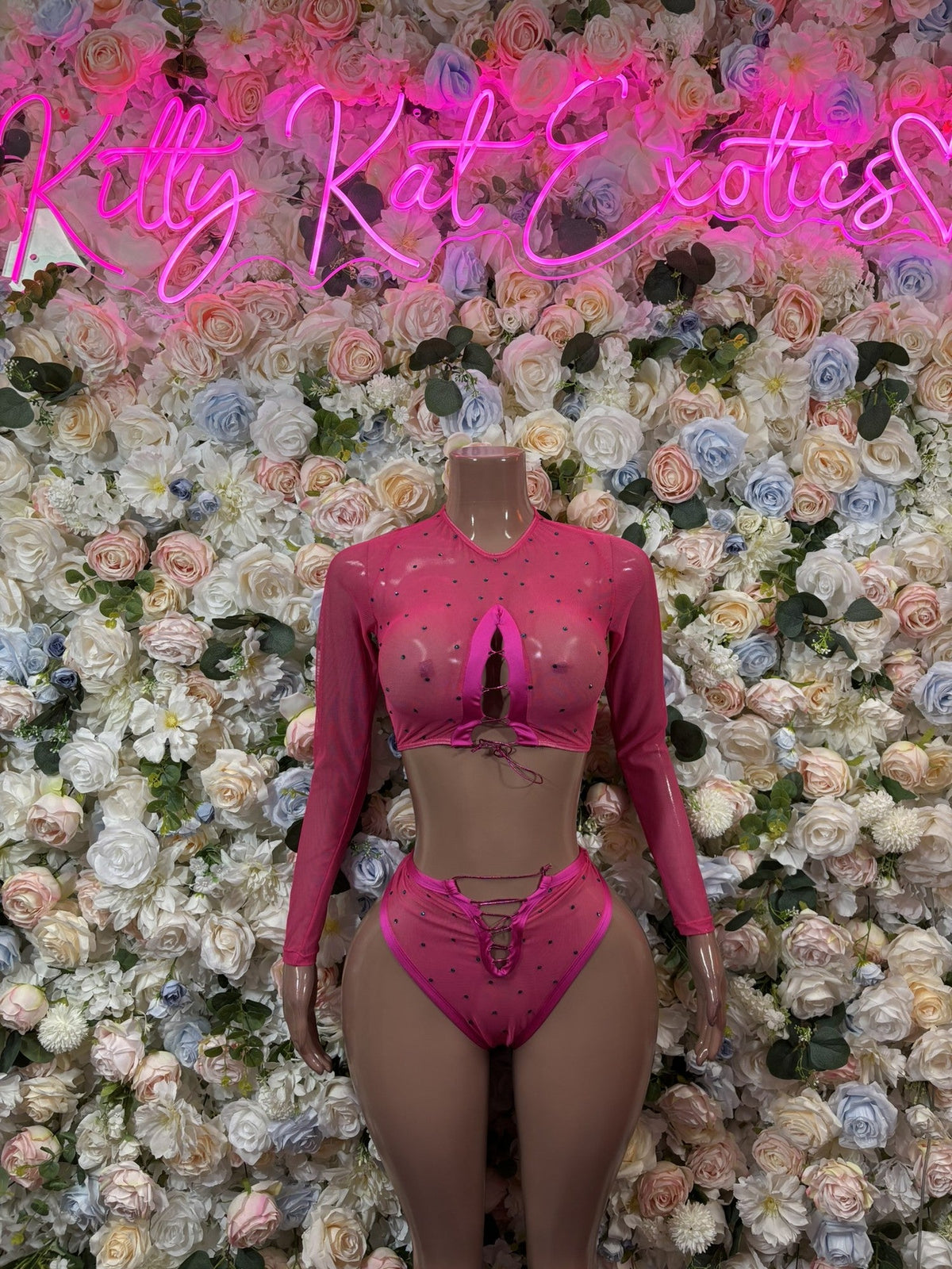 Pink long-sleeve cutout crop top and thong set, front view with high-cut bottoms