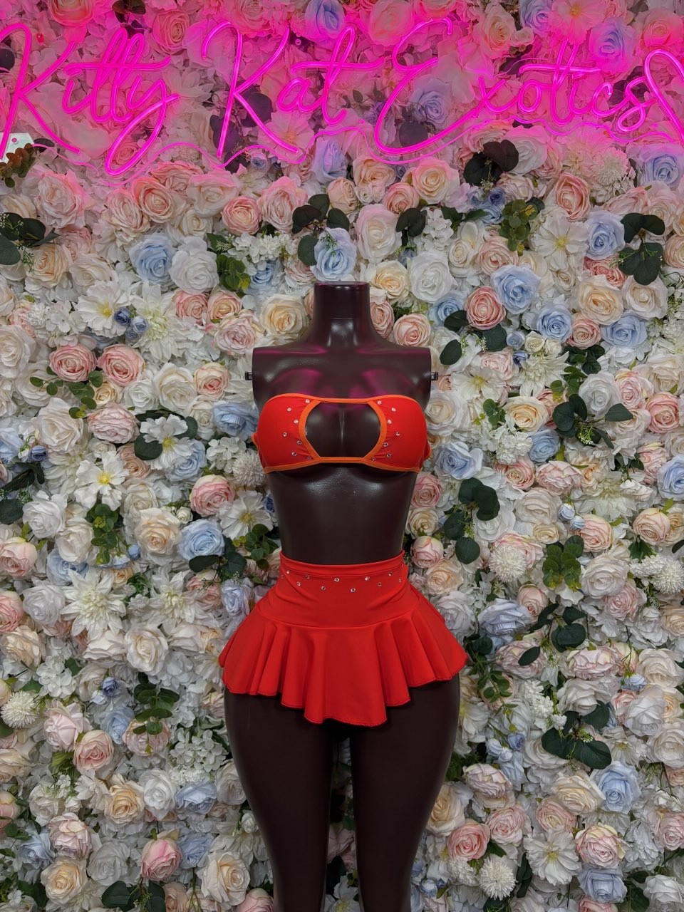 Red bandeau top with center buckle and matching red ruffle skirt set, full view