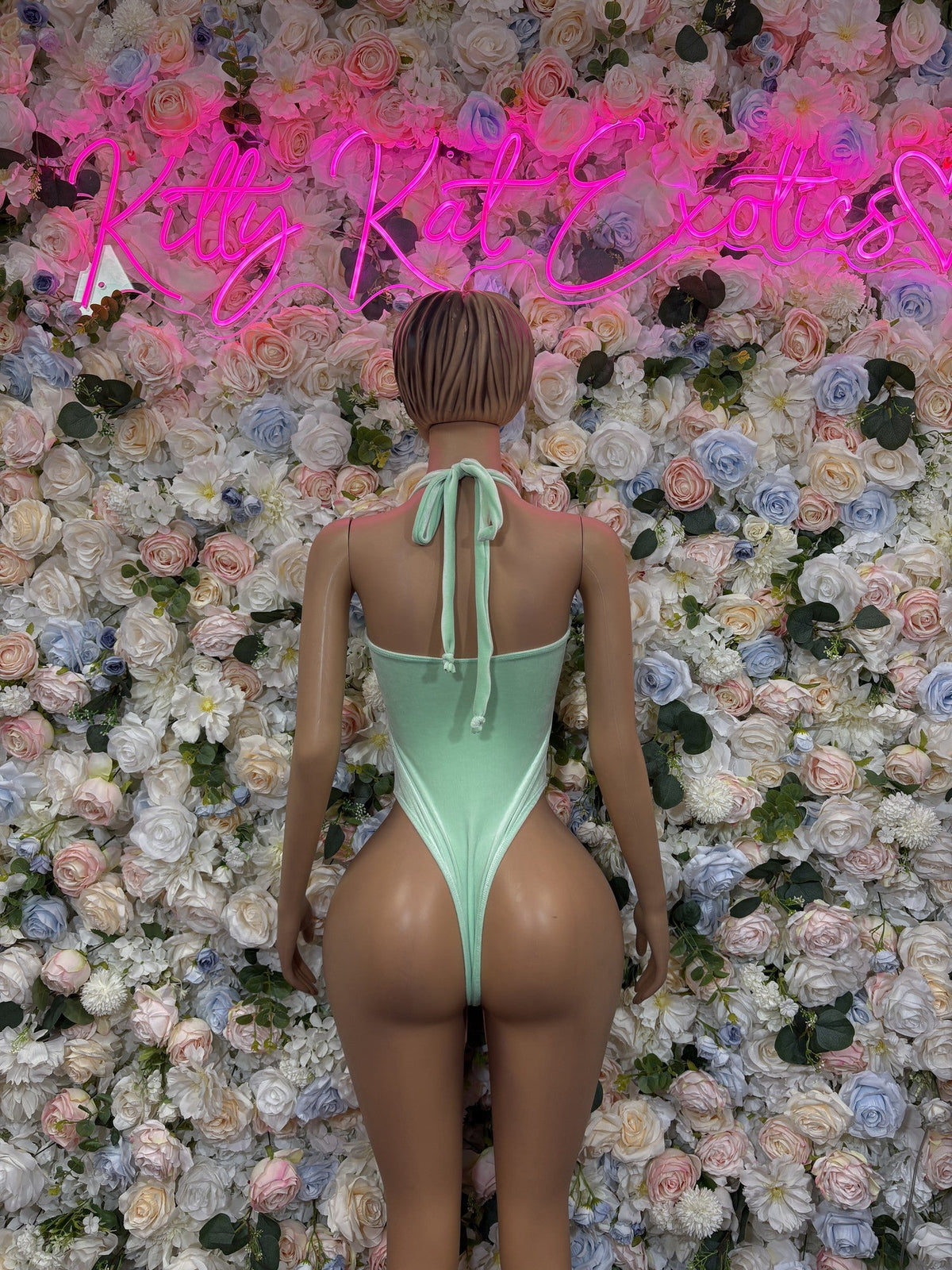 Mint green one-piece swimsuit with open back and tie at neckline