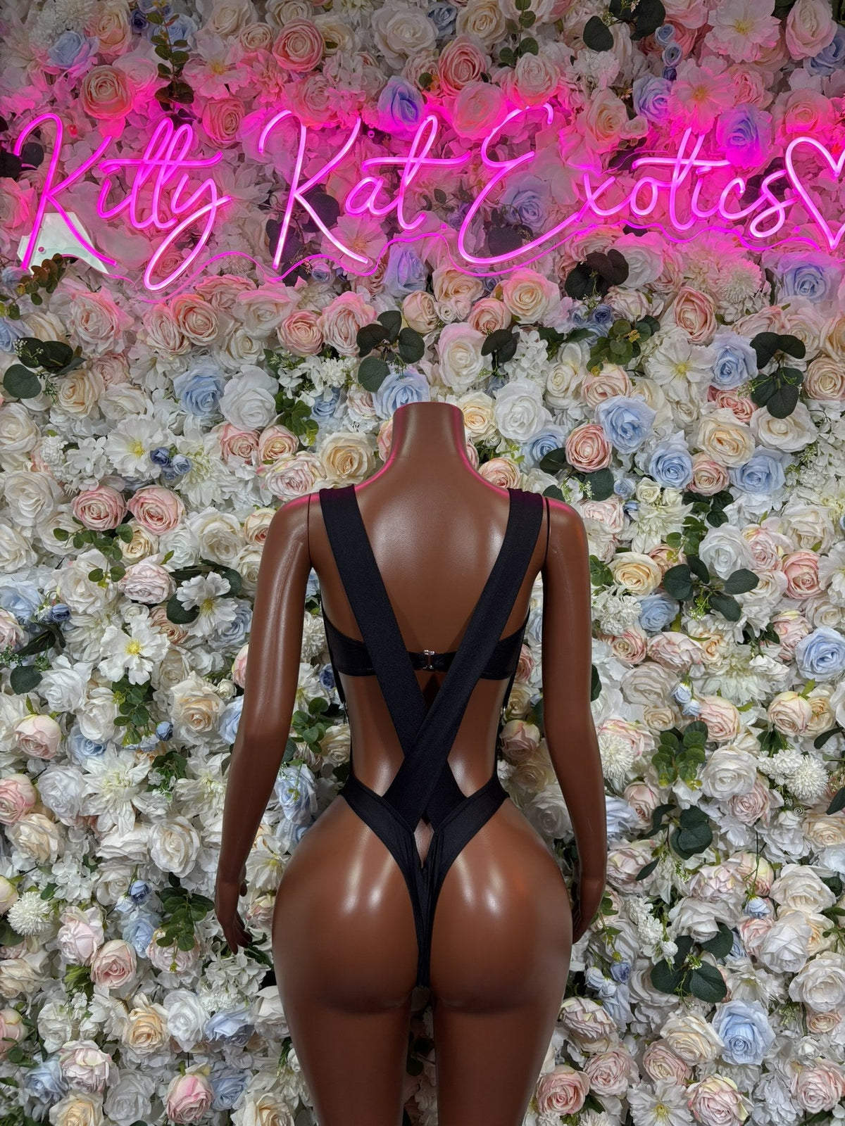 Back of the black dancewear set, showing crossed straps and cutout details