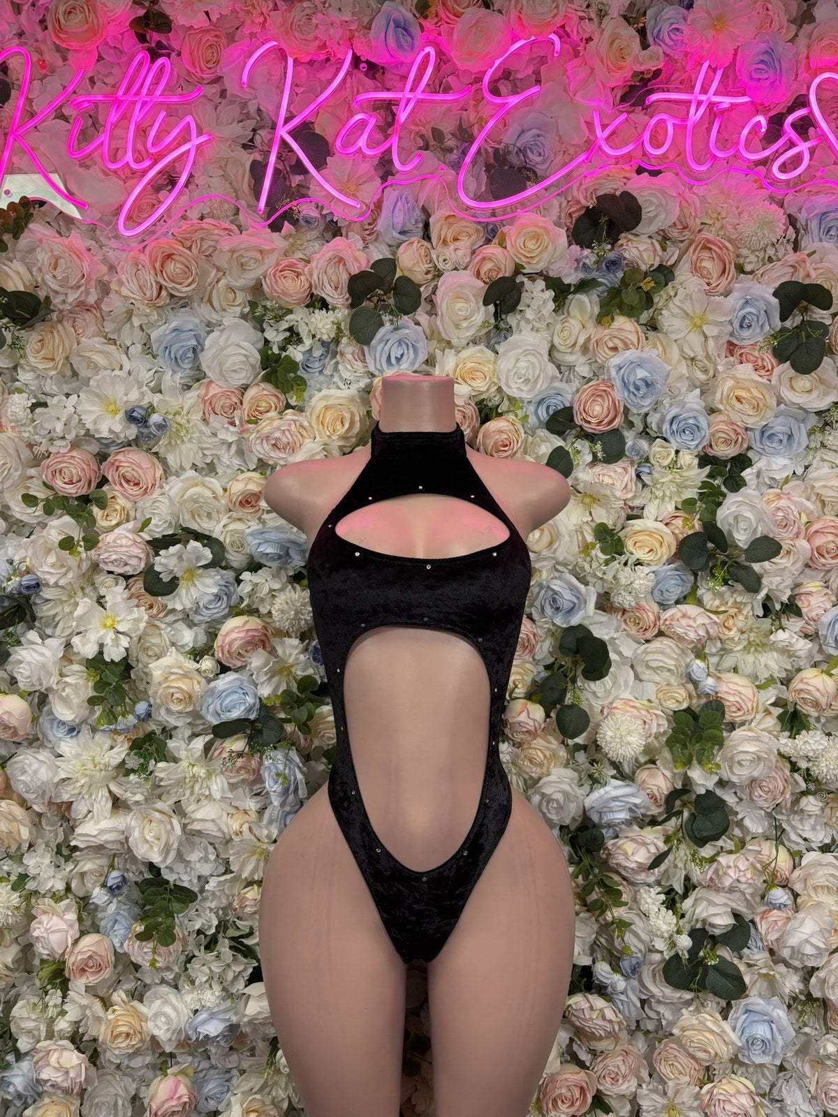 Black halter bodysuit with an open back and large oval front cutout