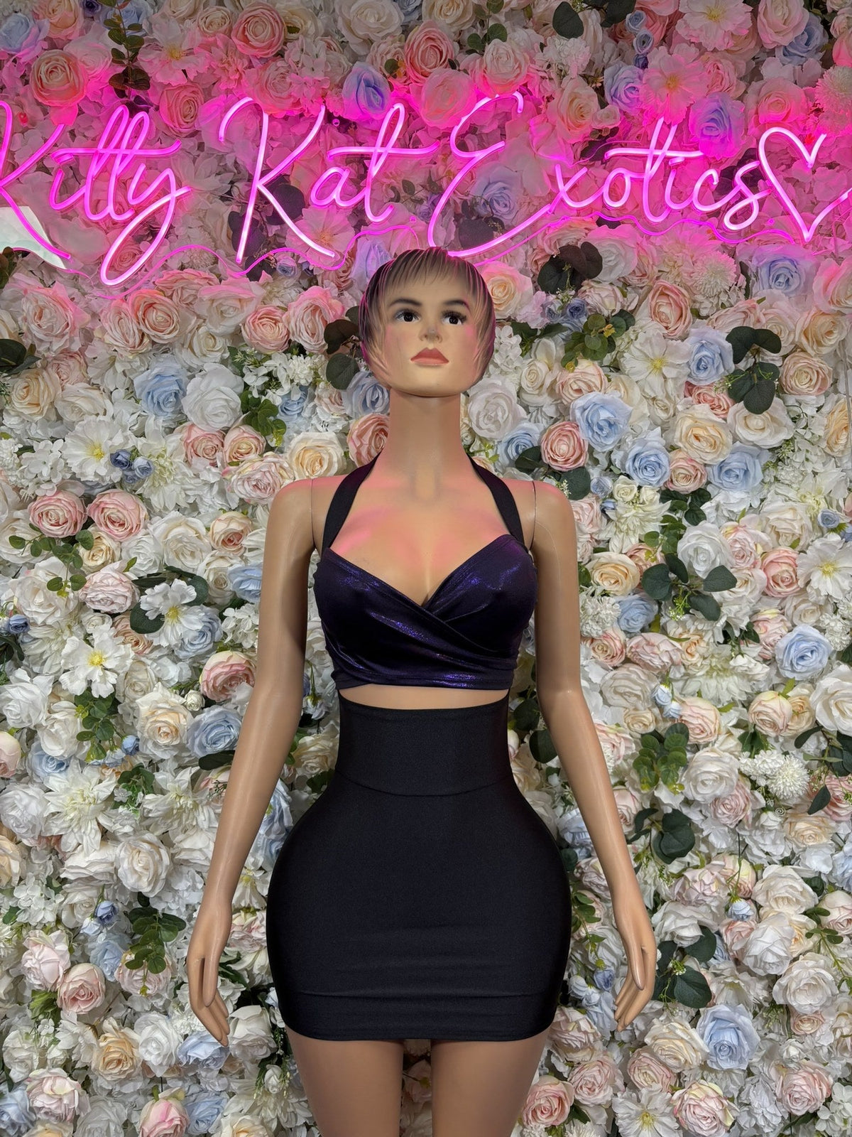 Navy crop top and mini skirt set with a glossy wrap-front halter top and fitted high-waist skirt