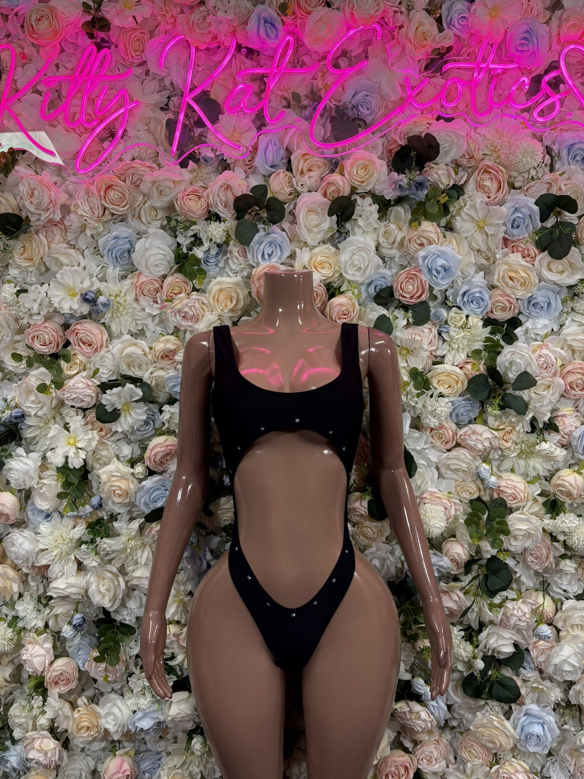 Black scoop-neck open-back bodysuit with wide straps and high-cut legs, front view
