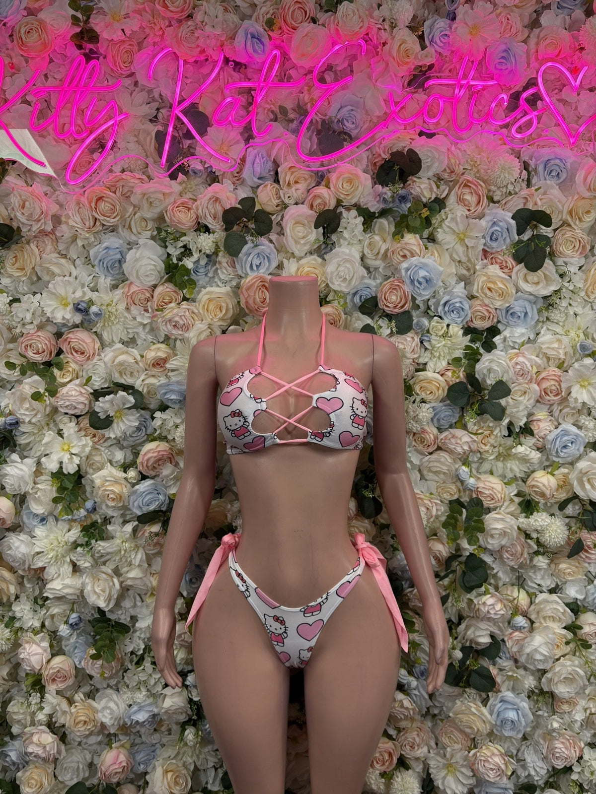 Pink print triangle bikini set with heart pattern, lace-up top, and tie-side bottoms