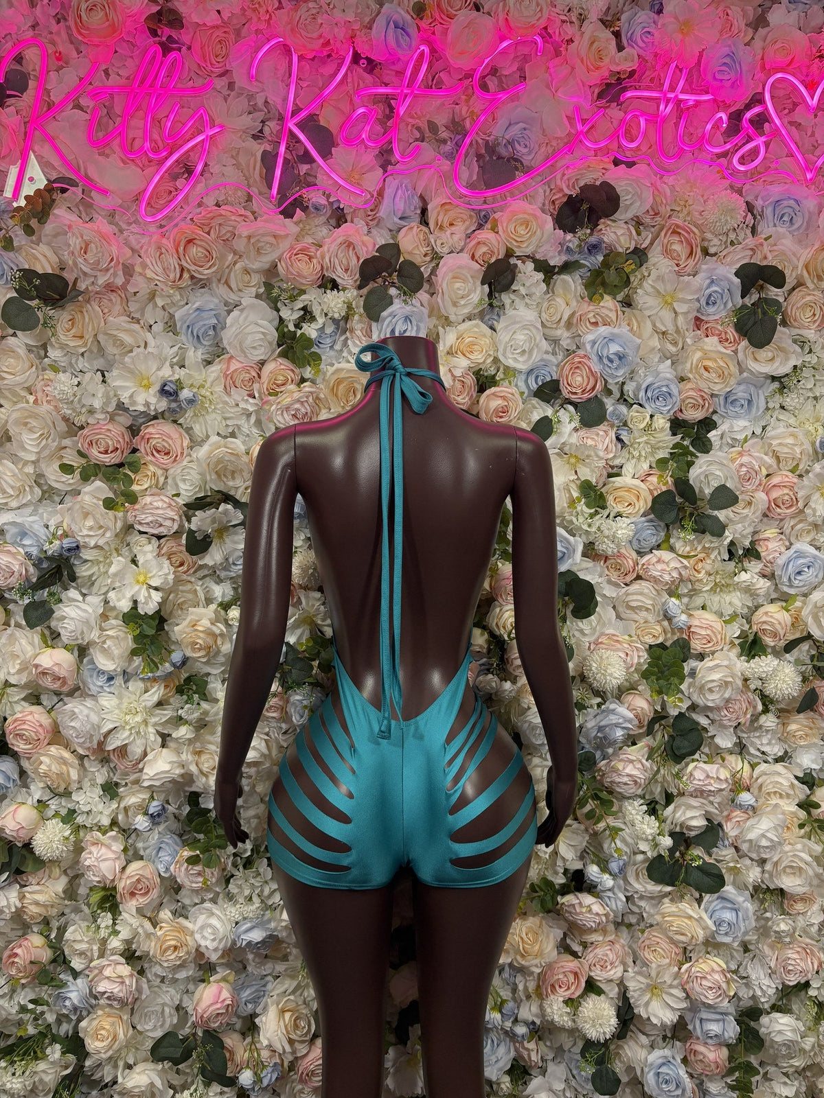 Turquoise open-back one-piece swimsuit with a halter tie and cutout sides