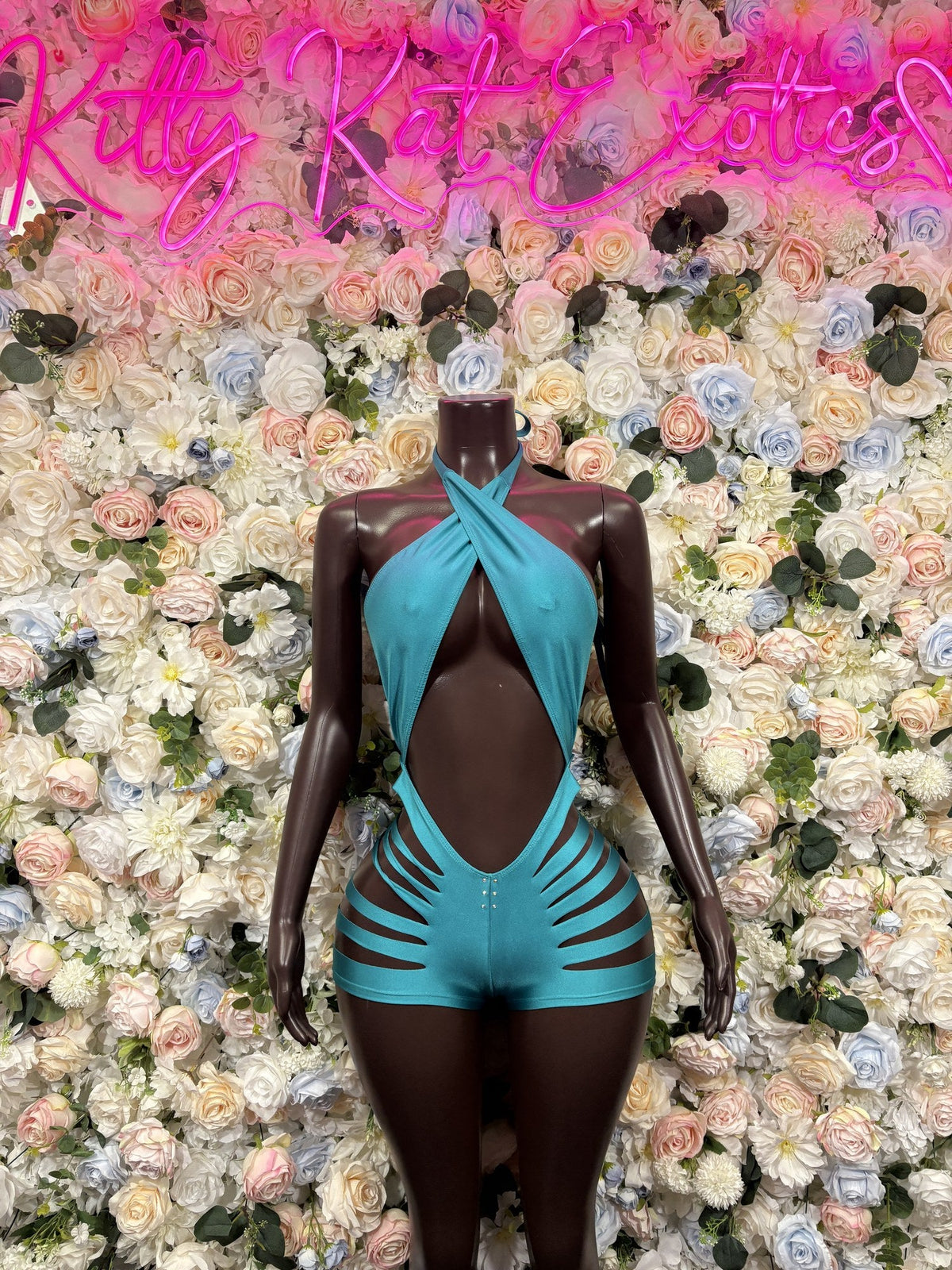 Turquoise one-piece swimsuit with a plunging front, halter straps, and cutout sides