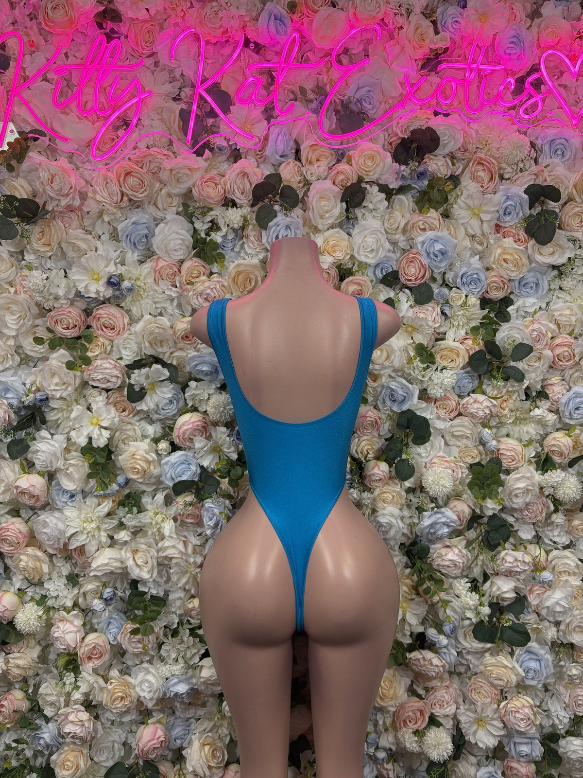 Bright blue high-cut one-piece bodysuit, shown from the back with a low scoop back