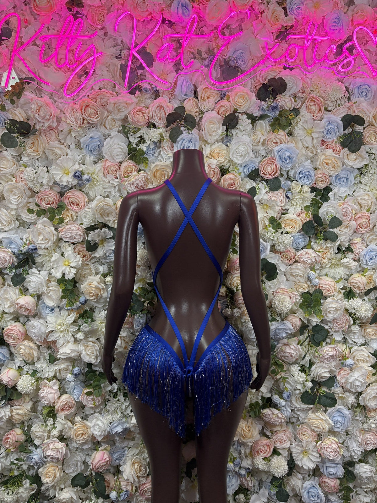 Royal blue strappy bodysuit with crossed back straps and long hip fringe, rear view