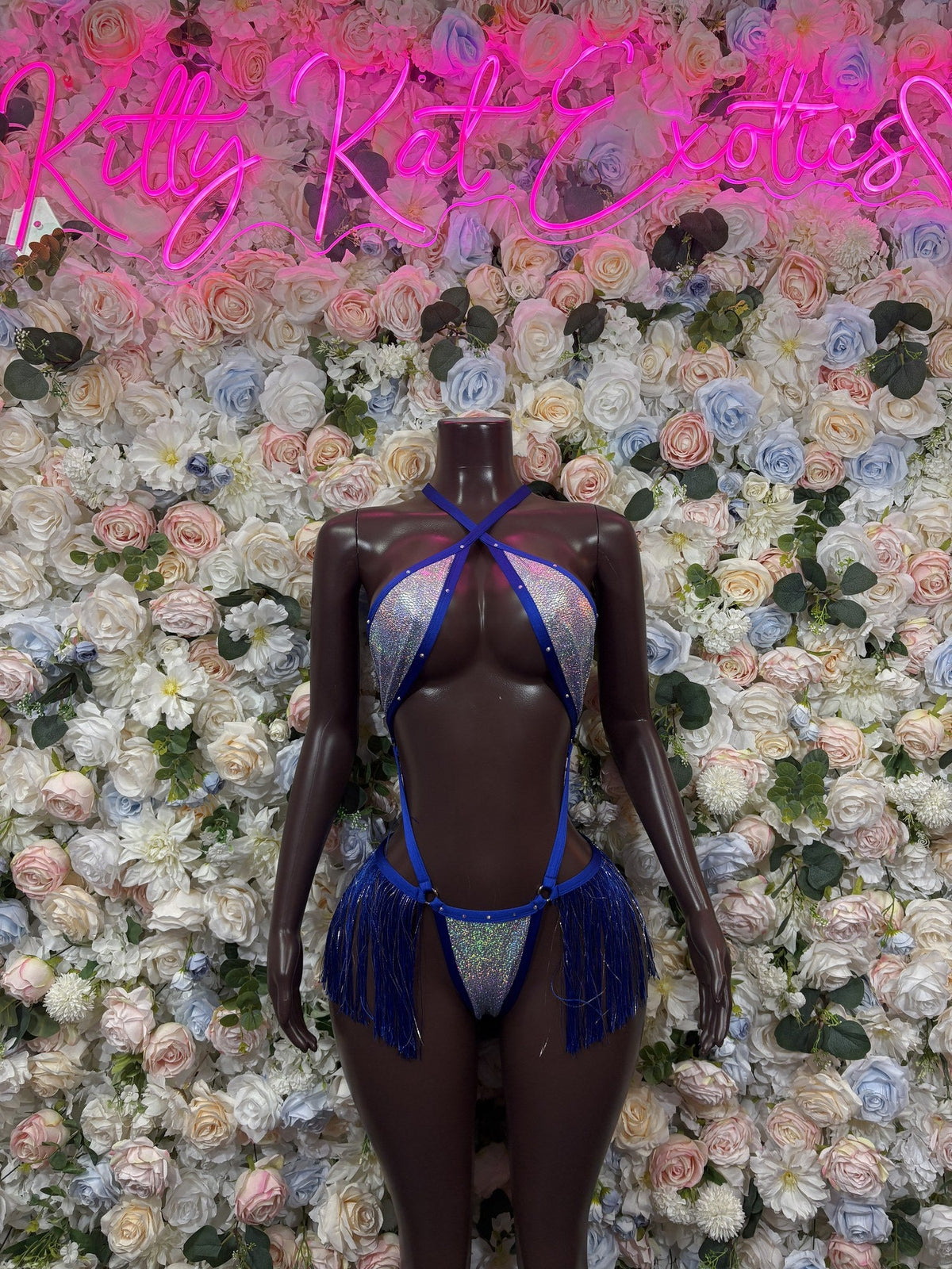Royal blue strappy cutout bodysuit with glitter panels and fringe at the hips, front view