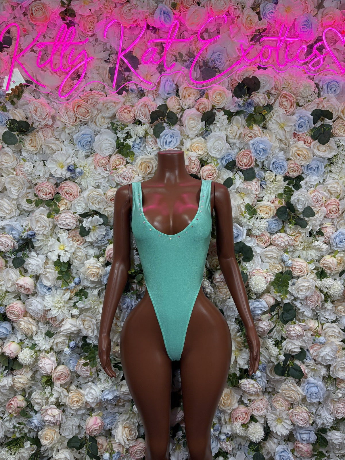 Mint green one-piece swimsuit with a scoop neckline, wide straps, and high-cut legs