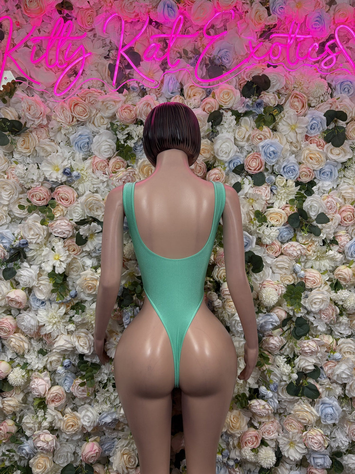 Mint green bodysuit with a low scoop back and high-cut legs