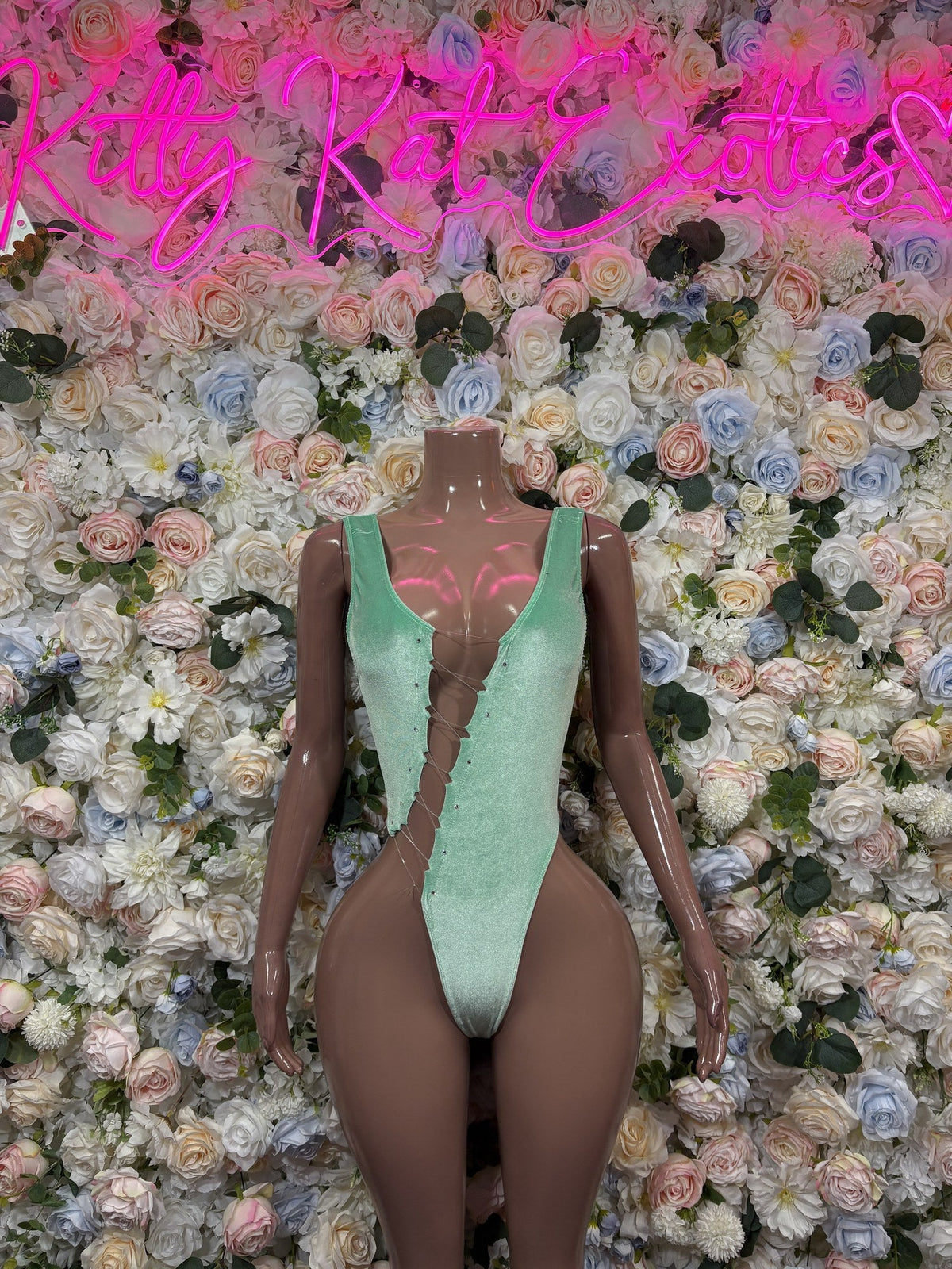 Mint green plunge bodysuit with deep V neckline and sheer cutout panels