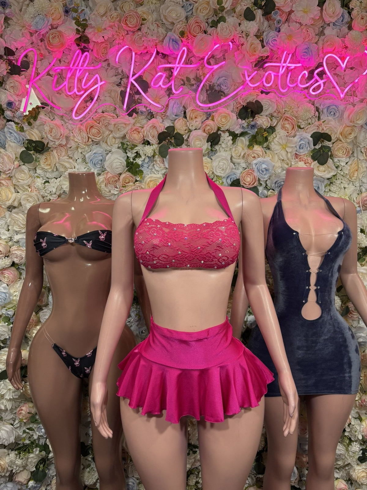 Black rhinestone bra and thong set displayed beside other lingerie