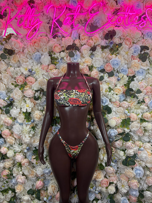 Multicolor high-neck cutout bikini set with floral pattern and string bottoms on dark fabric