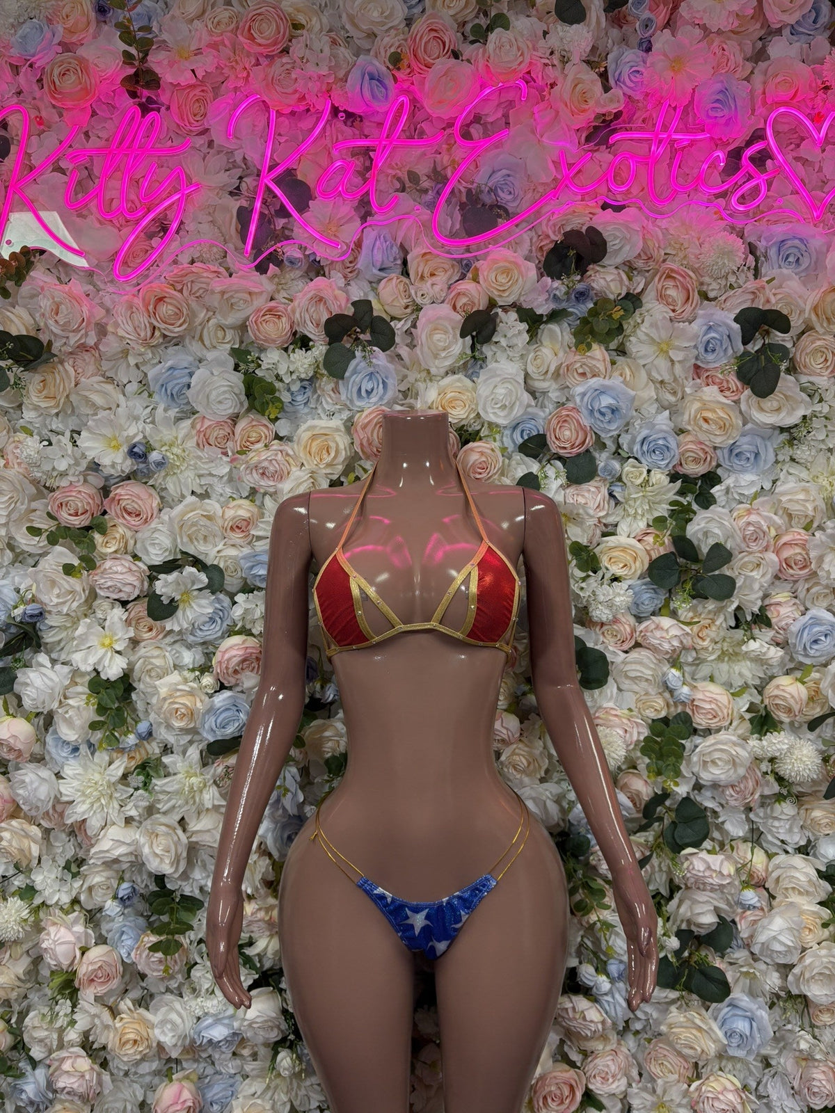 Women’s two-piece bikini with red top, blue bottoms, and gold-trim detail