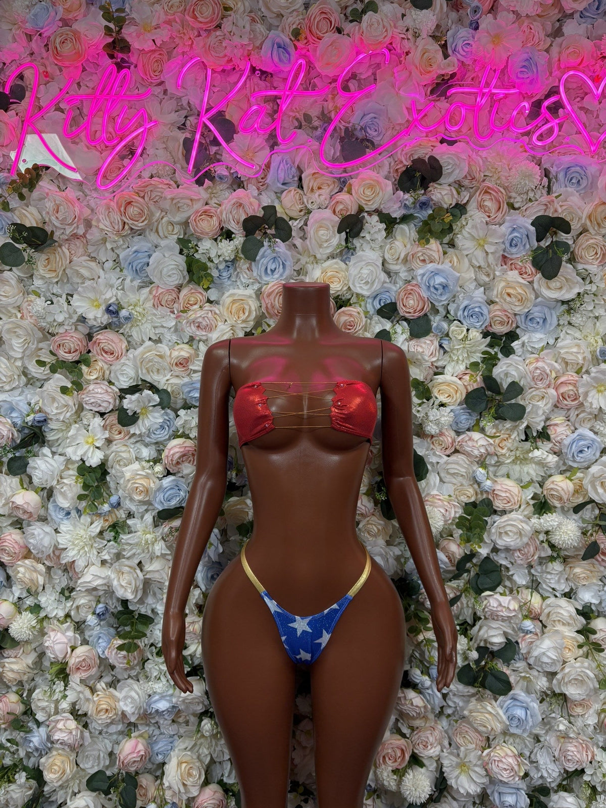 Front view red bandeau bikini with gold trim and blue star-print bottoms