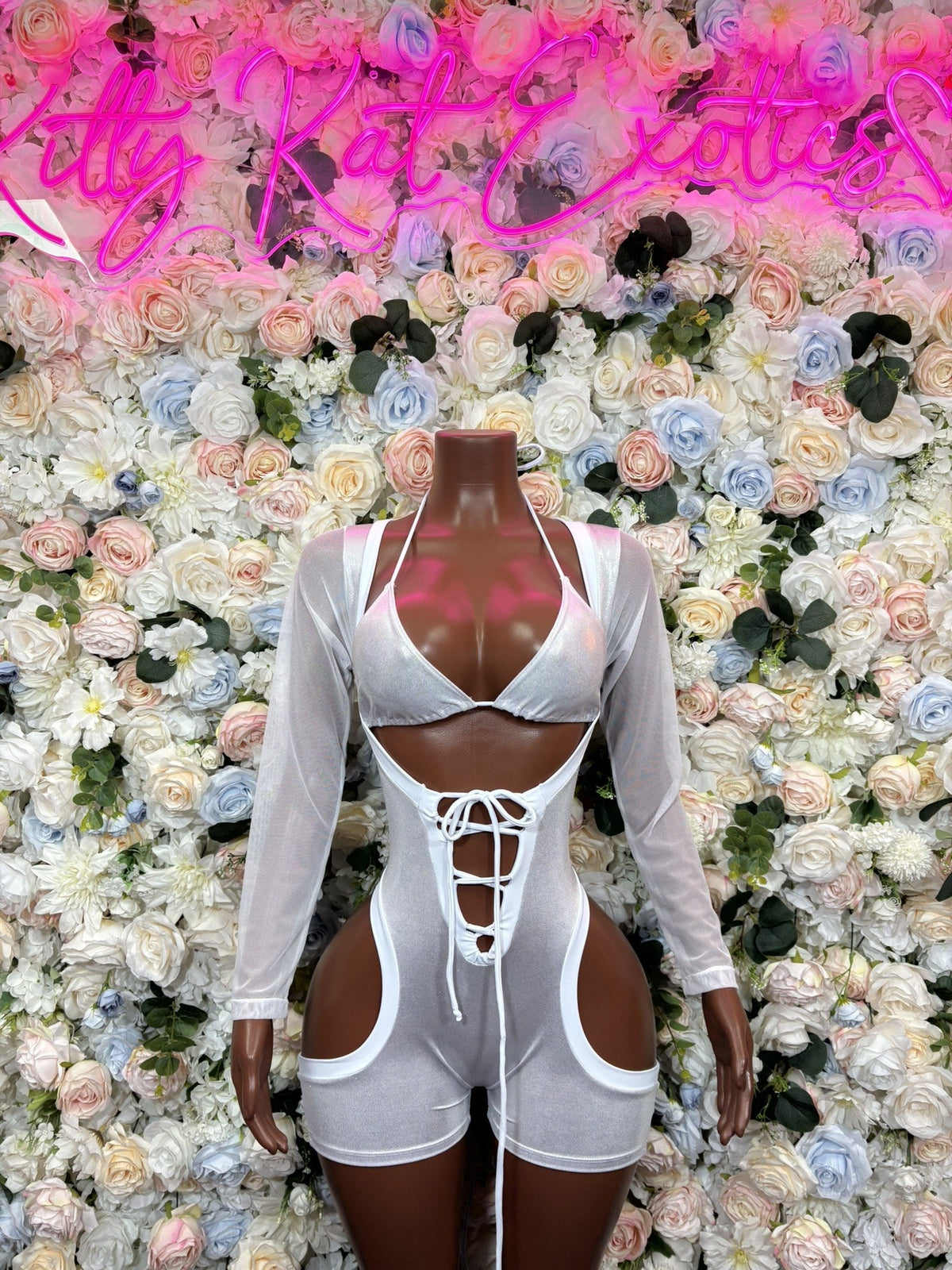 White long-sleeve cutout bodysuit with shorts, lace-up front and side openings