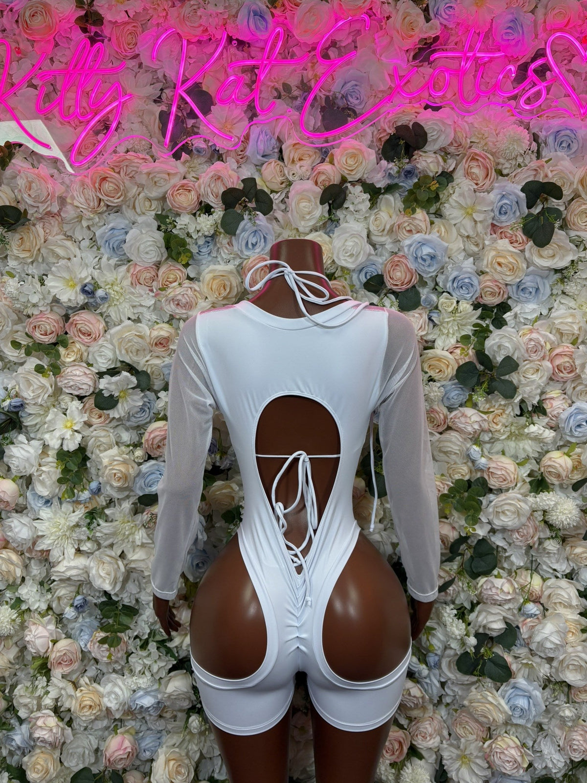 White long-sleeve cutout bodysuit with shorts, open back lace-up ties