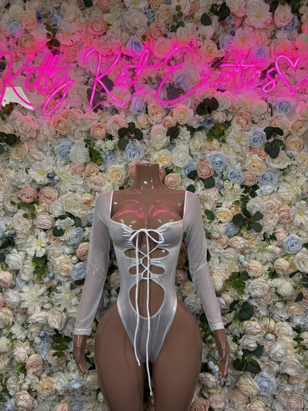White lace-up long-sleeve bodysuit, fitted thong-style bottom with center corset lacing