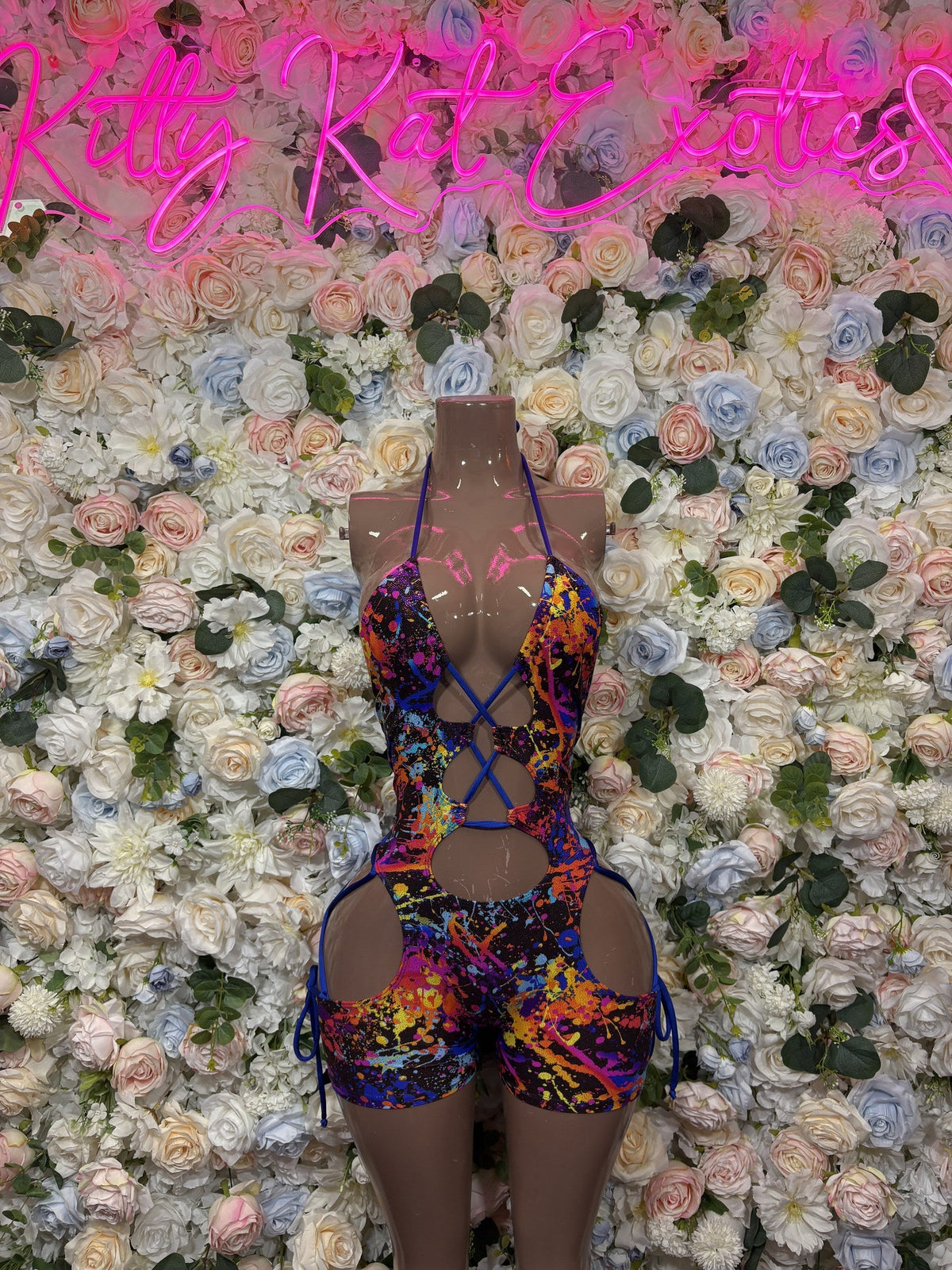 Blue bodysuit with multicolor print, deep V front, tie straps, high-leg cutouts