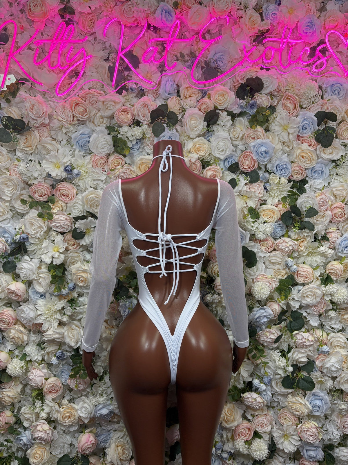 White iridescent cutout bodysuit with long sleeves and lace-up open back