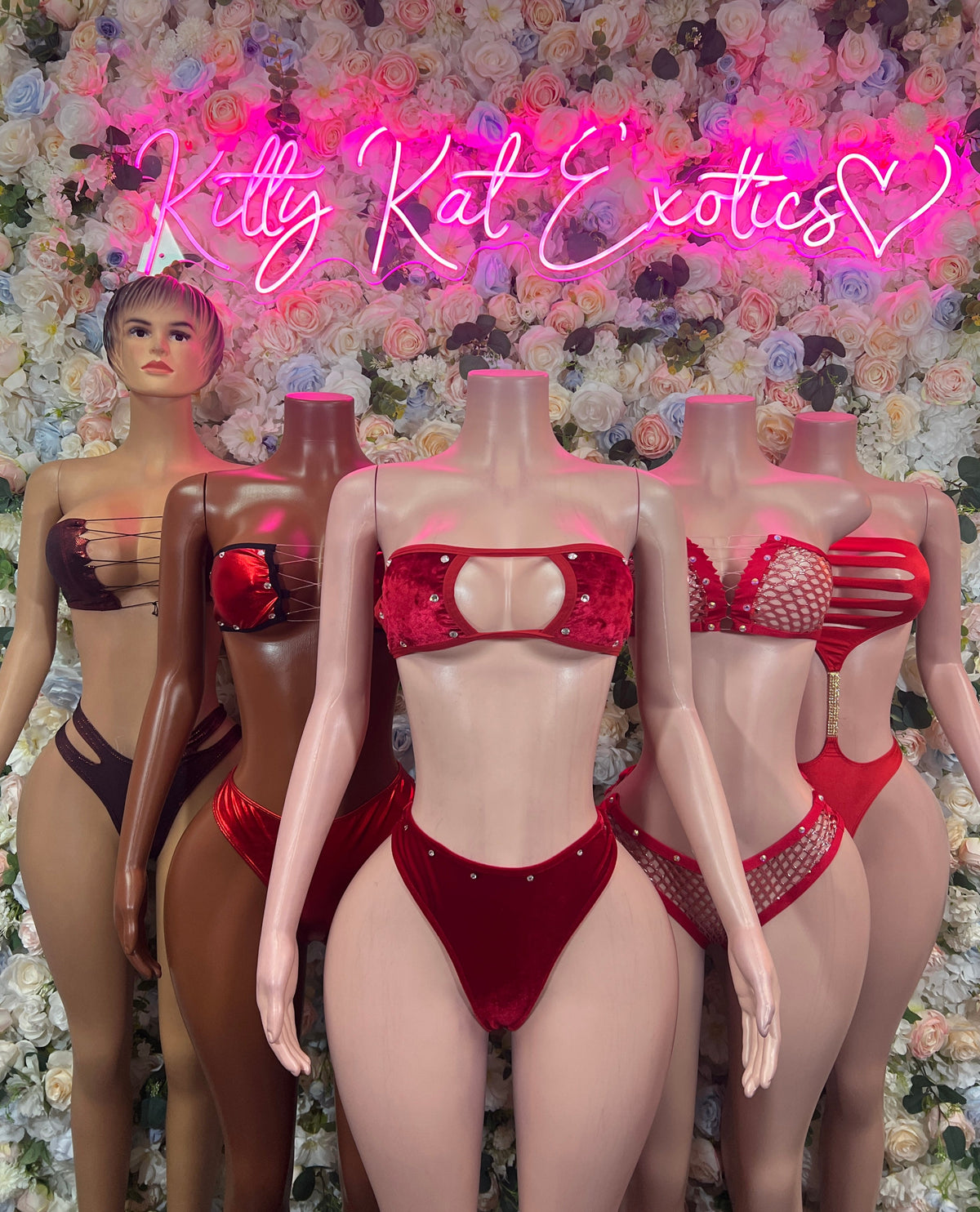 Red strappy cutout one-piece bodysuit on mannequins, front and back views