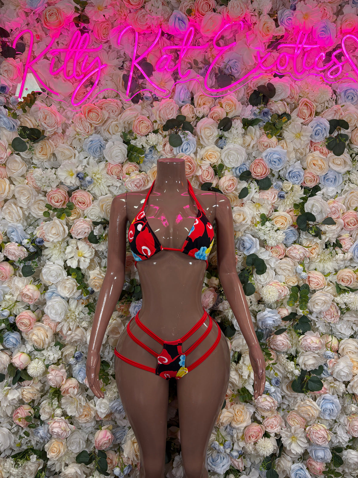 Red and black strappy bikini set: triangle top, high-waist bottoms on mannequin