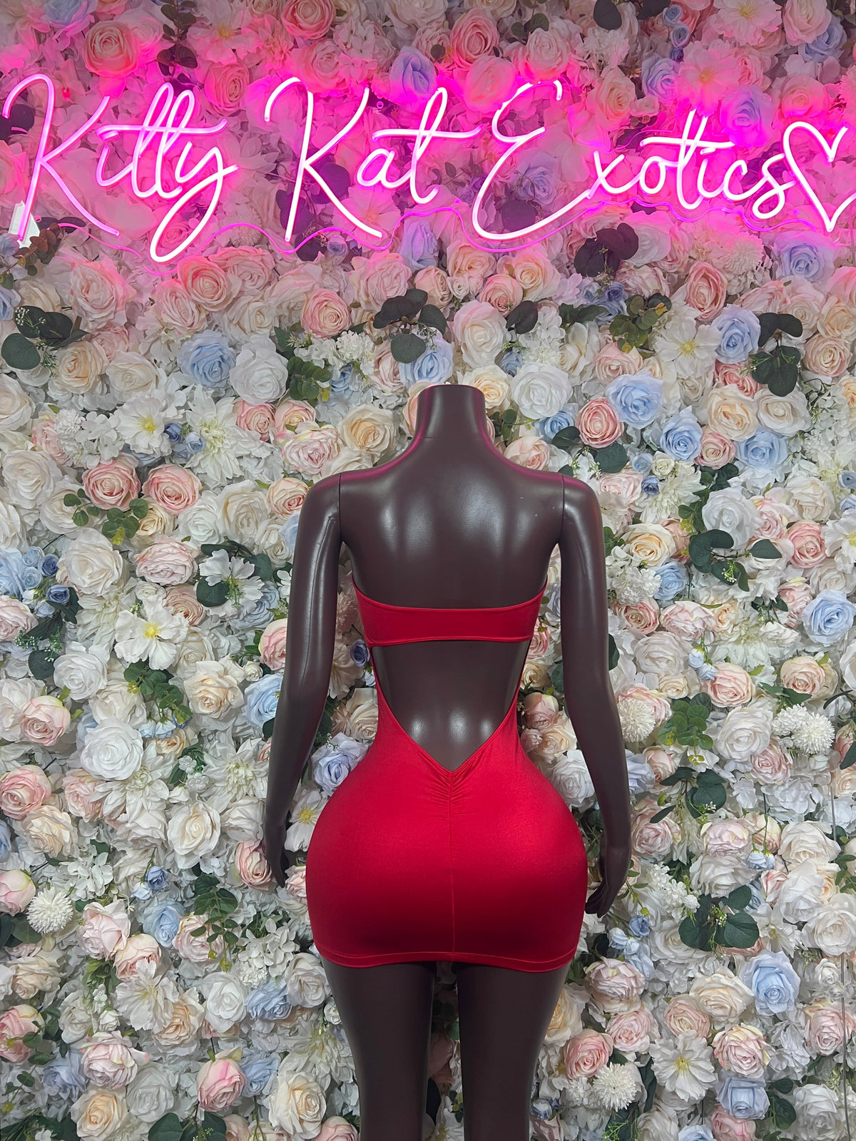 Red rhinestone mini dress with cutout back detail, rear view on mannequin