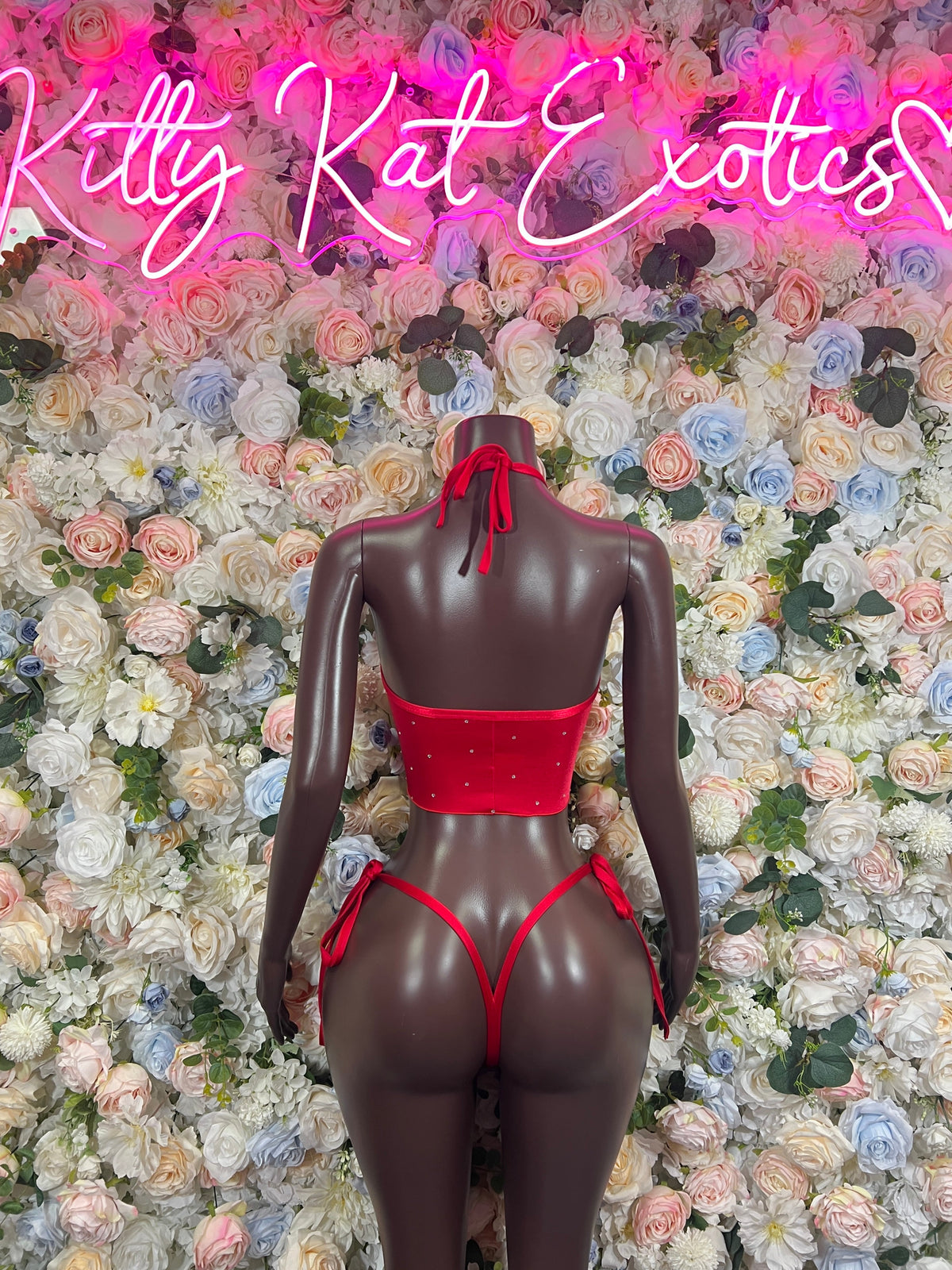 Red rhinestone scoop-neck two-piece set with strappy back and tie details on mannequin
