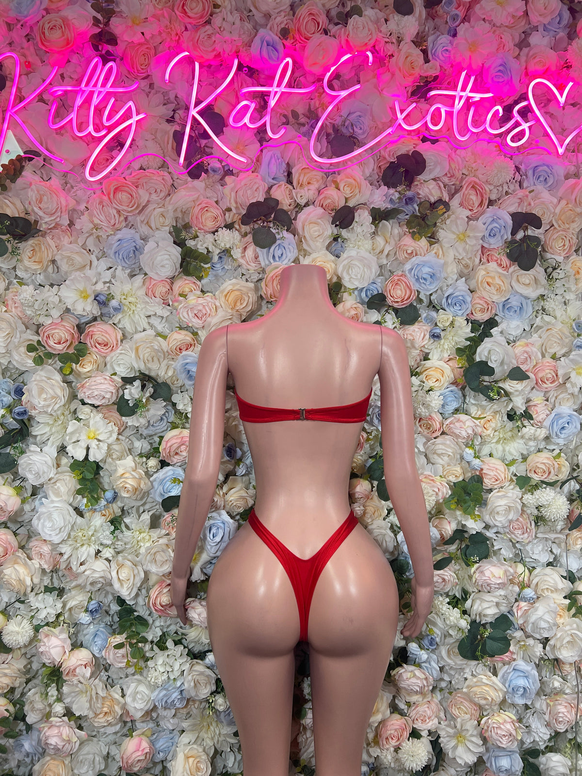 Red strappy cutout one-piece bodysuit, back view with high-cut thong