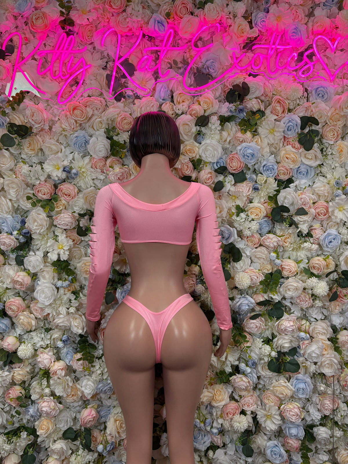 Pink long-sleeve cutout bikini set with open-back design and V-cut thong bottoms (rear view)