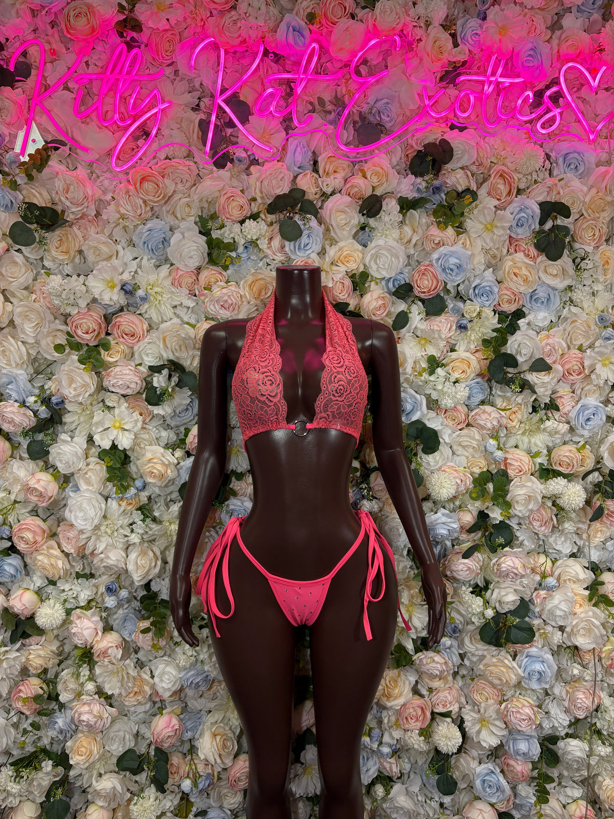 Hot pink lace bodysuit with open front, tie sides, and triangle thong bottom