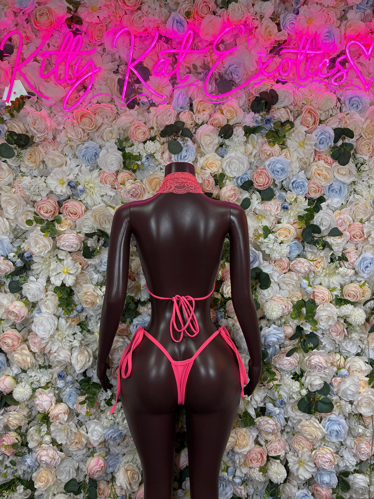 Hot pink lace cutout bodysuit with tie-back and crisscross strings, thong front