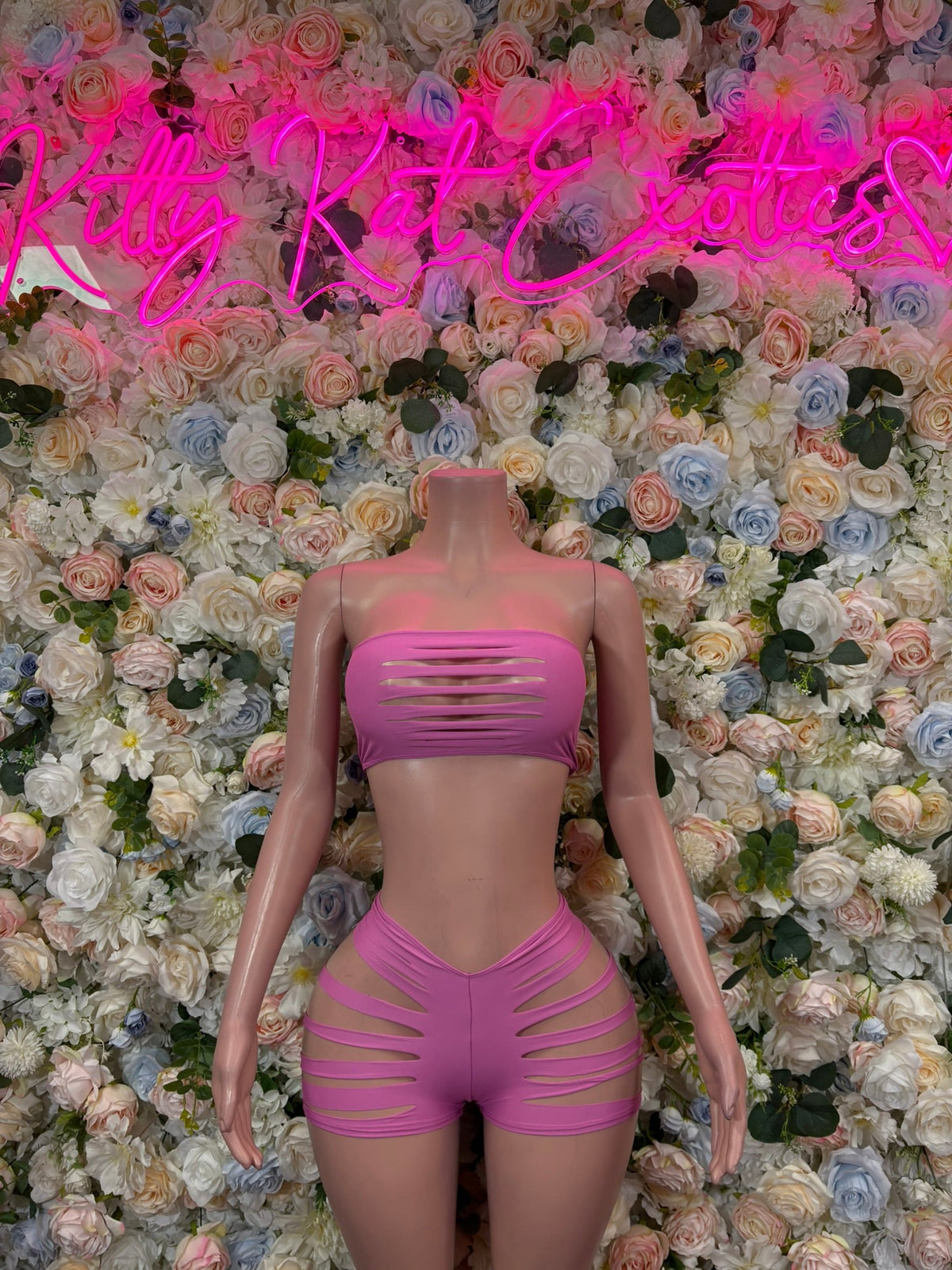 Pink strapless bandeau top with horizontal slash cutouts and matching high-rise shorts