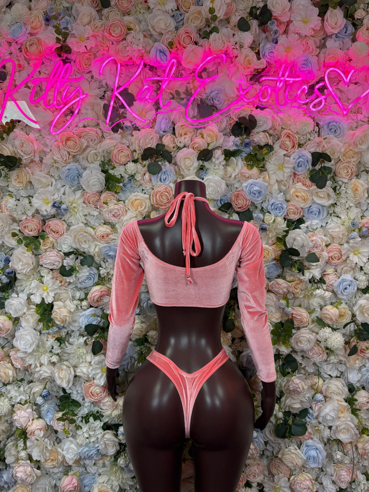 Pink long-sleeve crop top with tie-back neckline and high-cut thong two-piece set