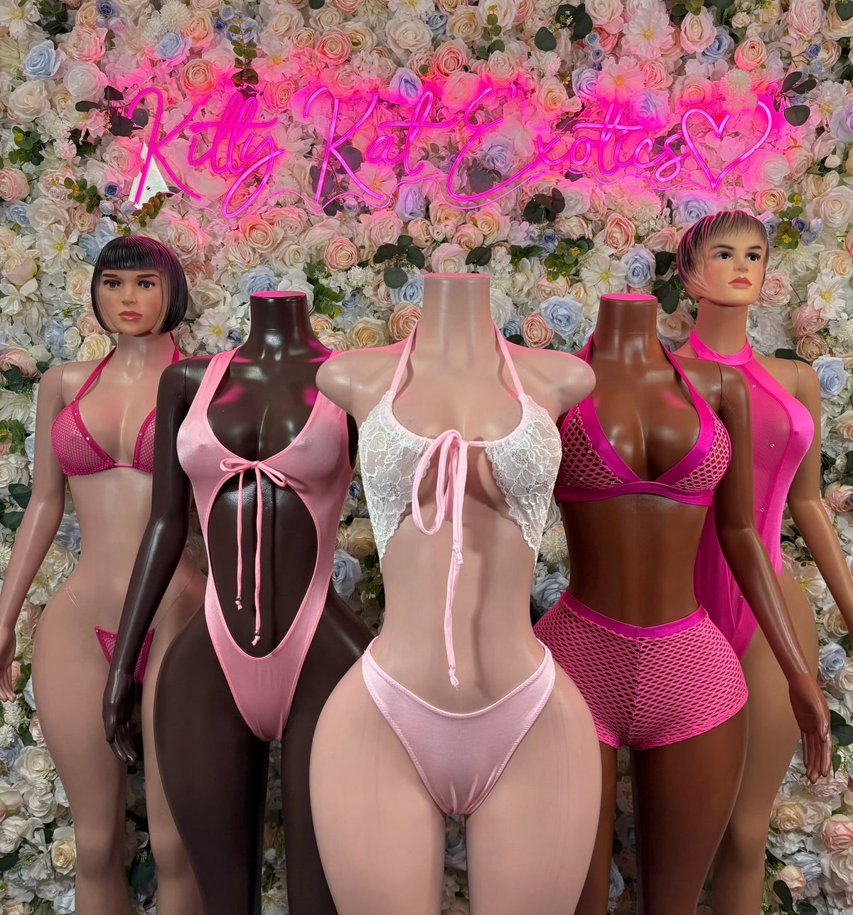Micro bikini set on mannequins: hot pink and white, triangle bras and matching bottoms