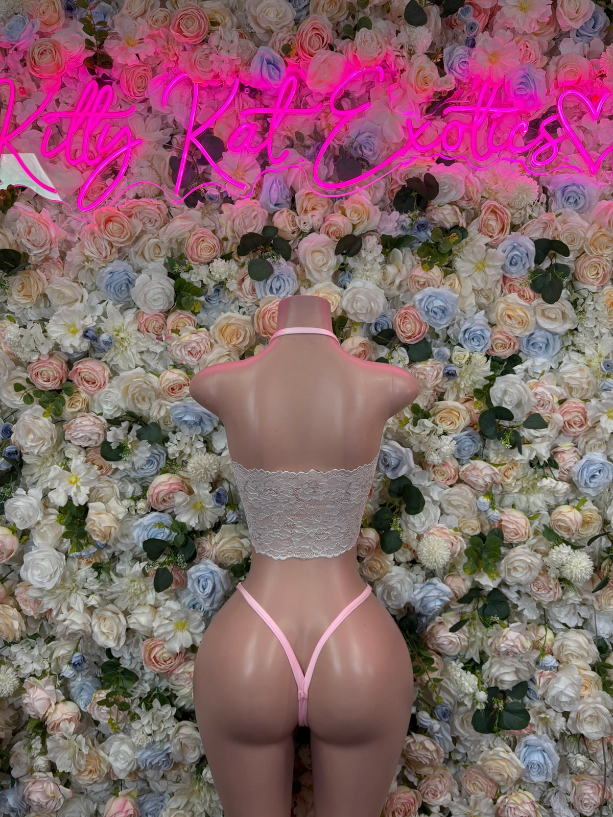 Pink lace bodysuit back view with bow ties and strappy back