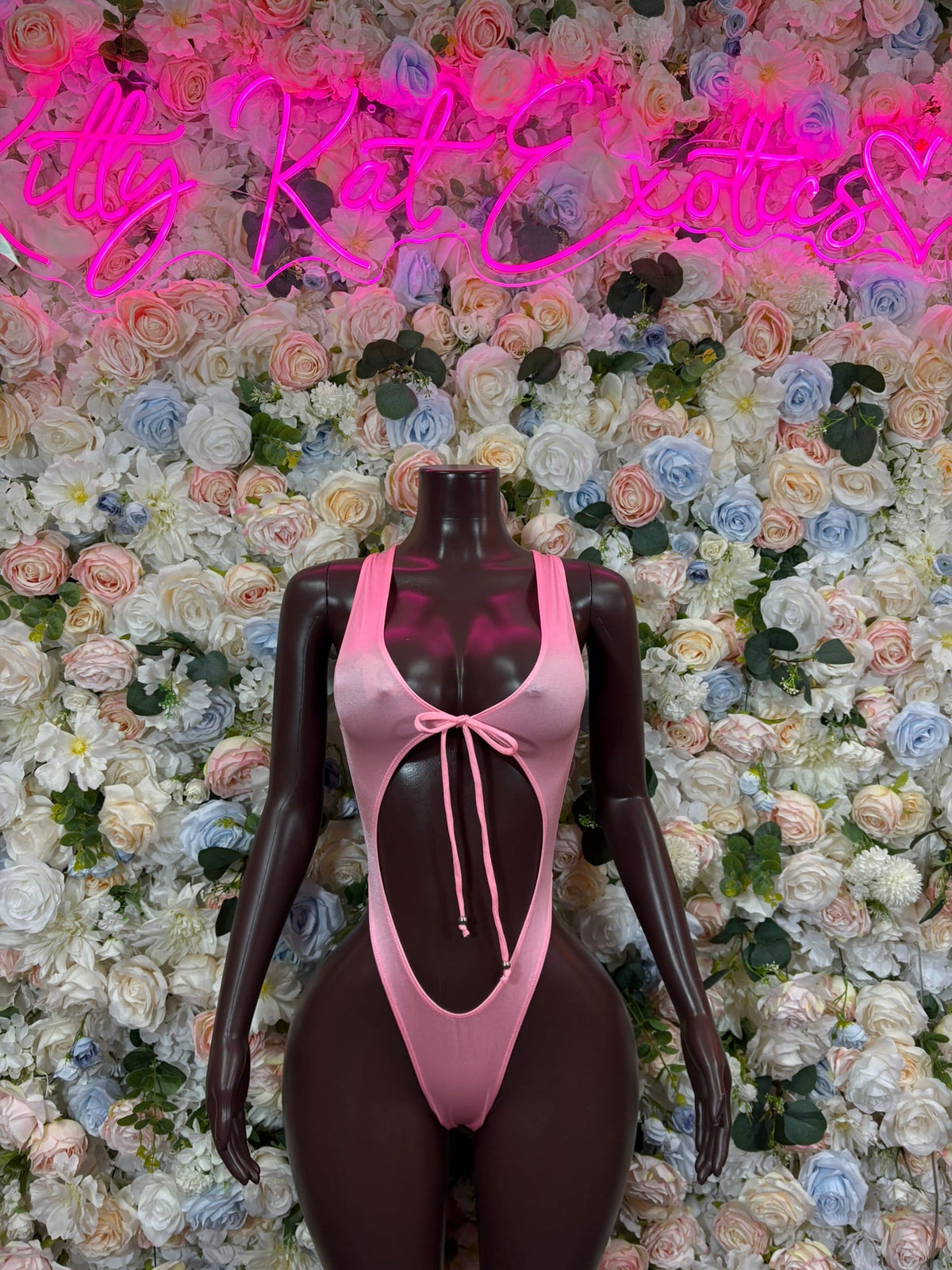 Baby pink ring cutout bodysuit with front bow and thin crisscross straps