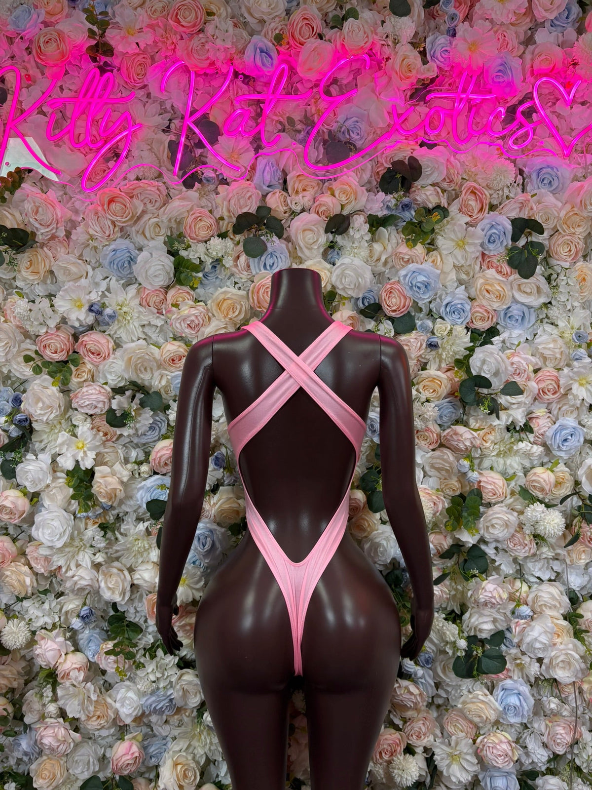 Baby pink ring cutout bodysuit with open back and crisscross straps