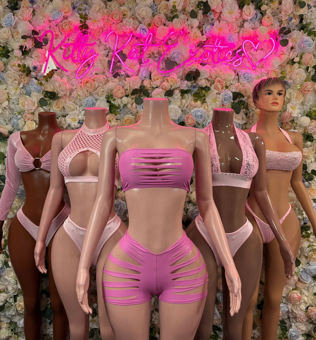 Baby pink lace bandeau bikini with matching strappy bottoms on mannequin