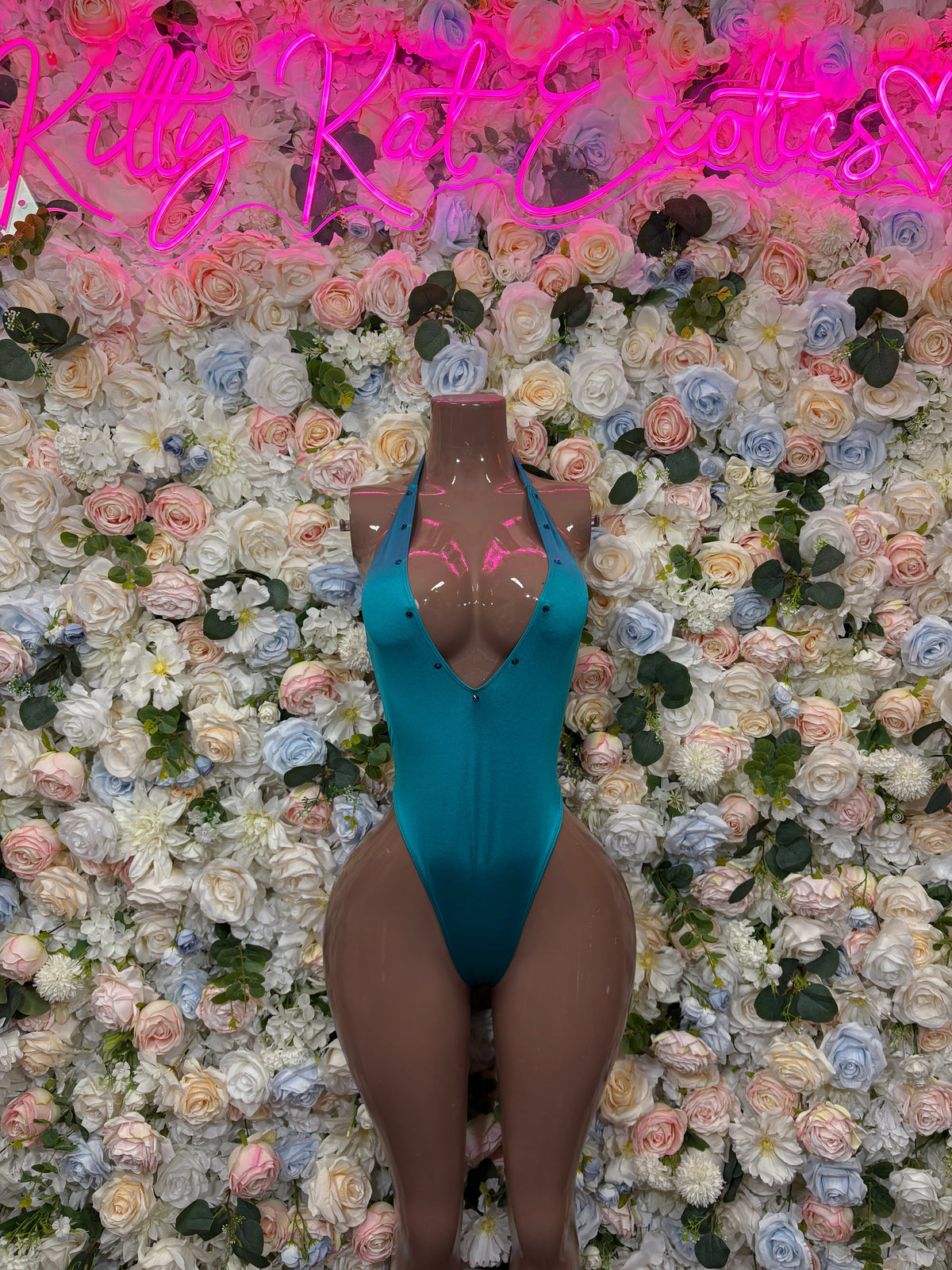 Teal plunge one-piece swimsuit with deep V neckline and high-cut leg