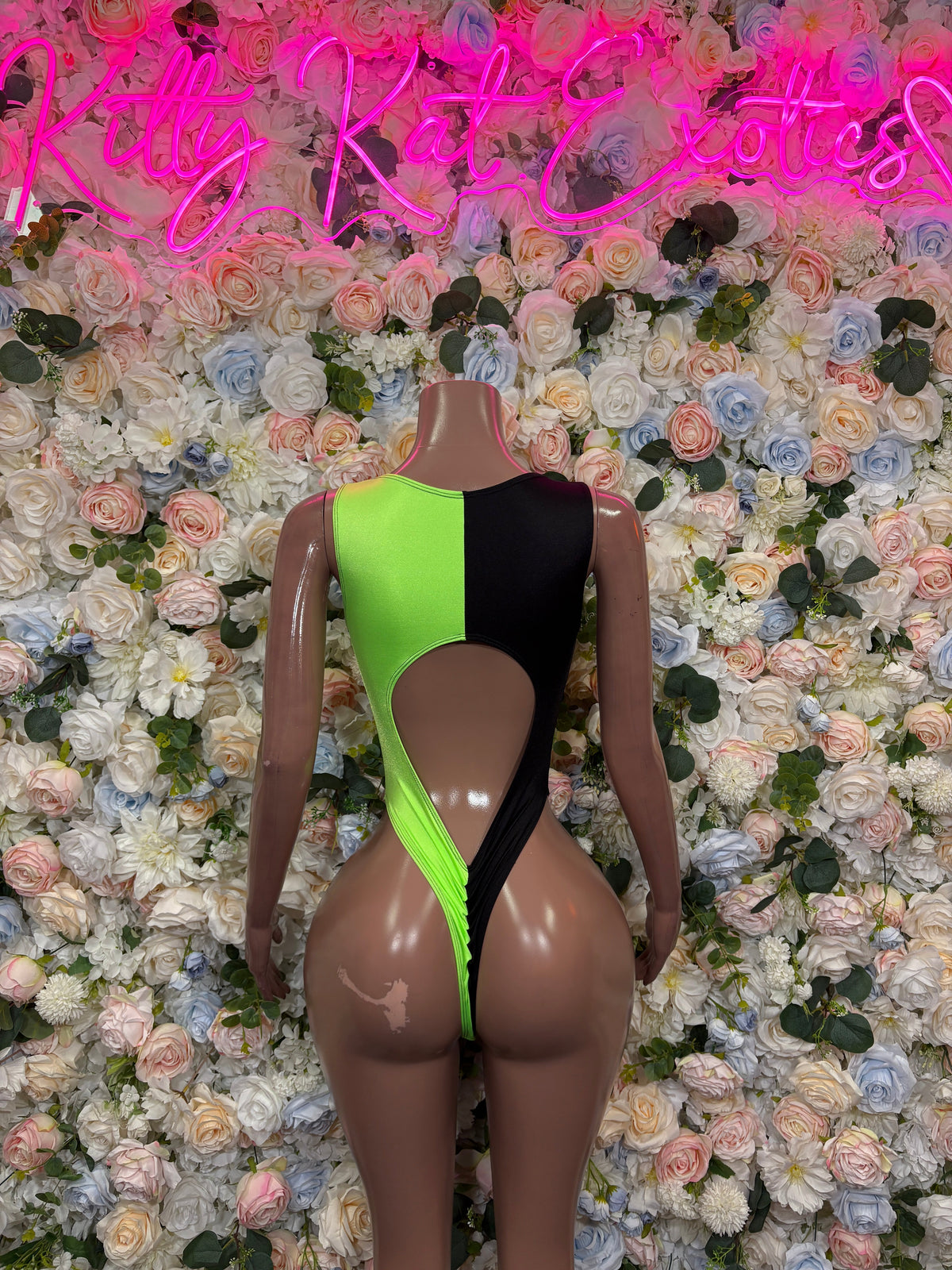 Neon green and black asymmetrical cutout bodysuit back view